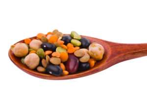 collection of beans, legumes, peas, lentils on wooden spoons